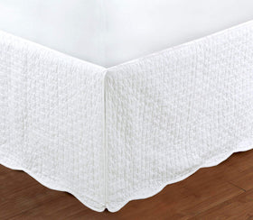 Cozy Line White Quilted Bed Skirt with a 16-inch drop drapes the queen bed.