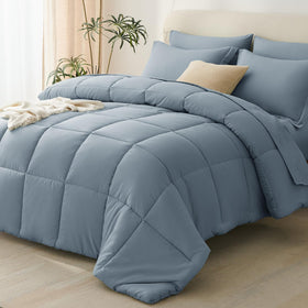 CozyLux grayish-blue comforter set on bed for all-season softness.