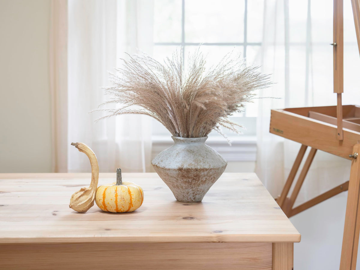 CozyWel rustic vase used as a centerpiece display with flowers and greens.