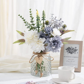 COZZI CODI blue silk flowers brighten living room decor with glass vase.