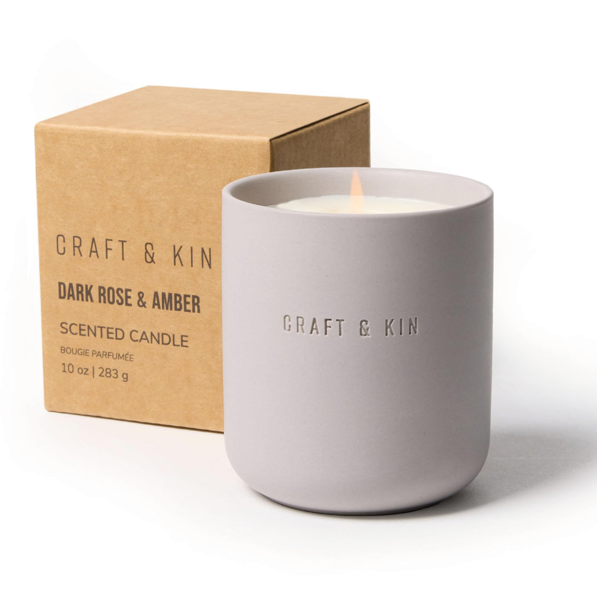 Craft & Kin Dark Rose & Amber candle in a green ceramic jar for cozy winter ambiance.
