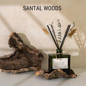 Craft & Kin green glass diffuser with Santal Woods scent for a warm woody atmosphere.