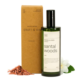 Craft & Kin Santal Woods room spray bottle releasing warm sandalwood aroma for bedding.