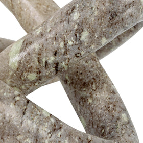 Beige marble link knot on coffee table as focal point