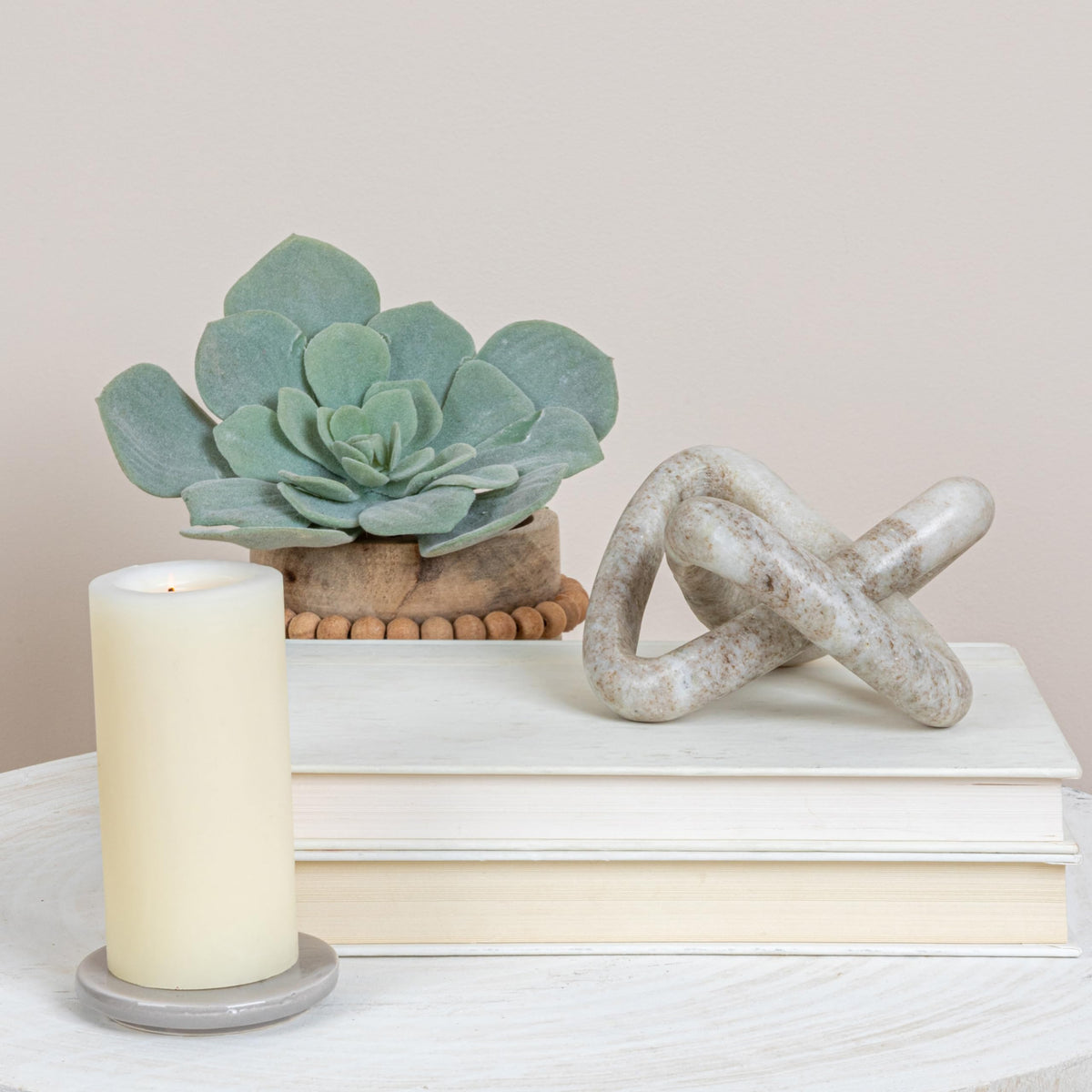 Sculptural beige marble knot by Creative Co-Op on display