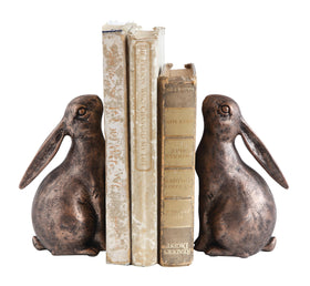 Creative Co-Op rabbit bookends bronze décor on living room shelf with rustic flair.