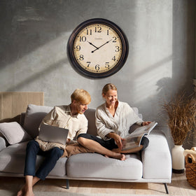 Crosstime 24-Inch clock enhances living room decor with a vintage touch.