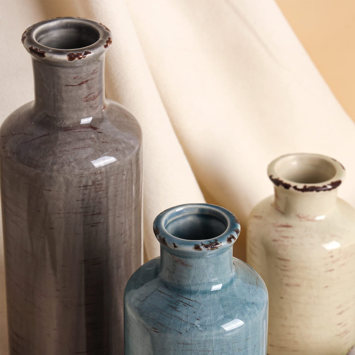 CUCUMI vases arranged on a shelf enhance coastal living room ambiance.