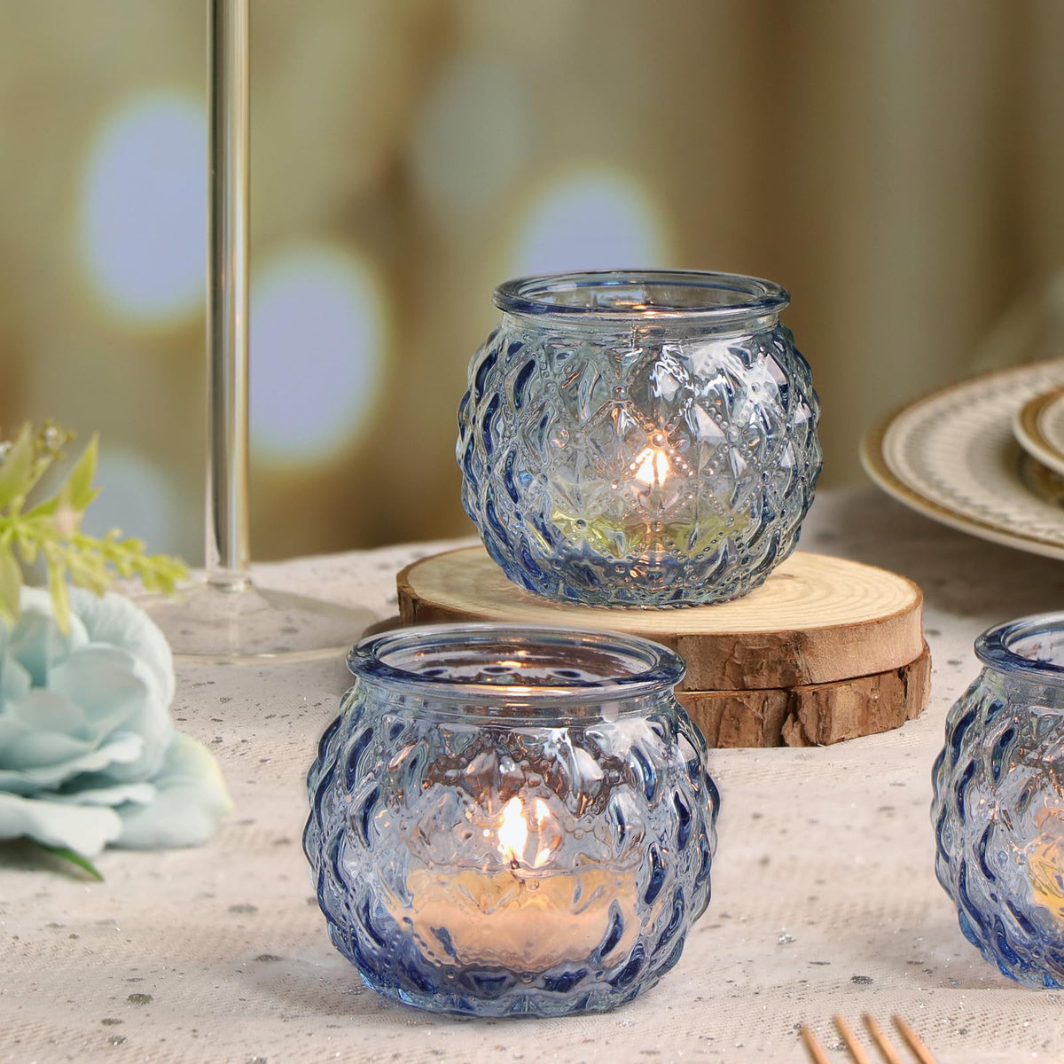DARJEN blue votive glass adds soft glow to dining room decor.