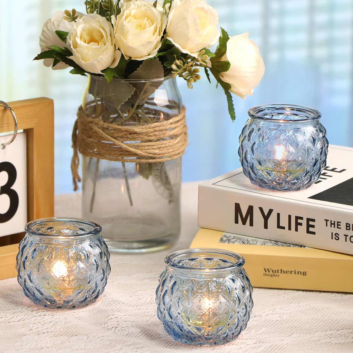 DARJEN blue votives compatible with tea lights for cozy lighting.