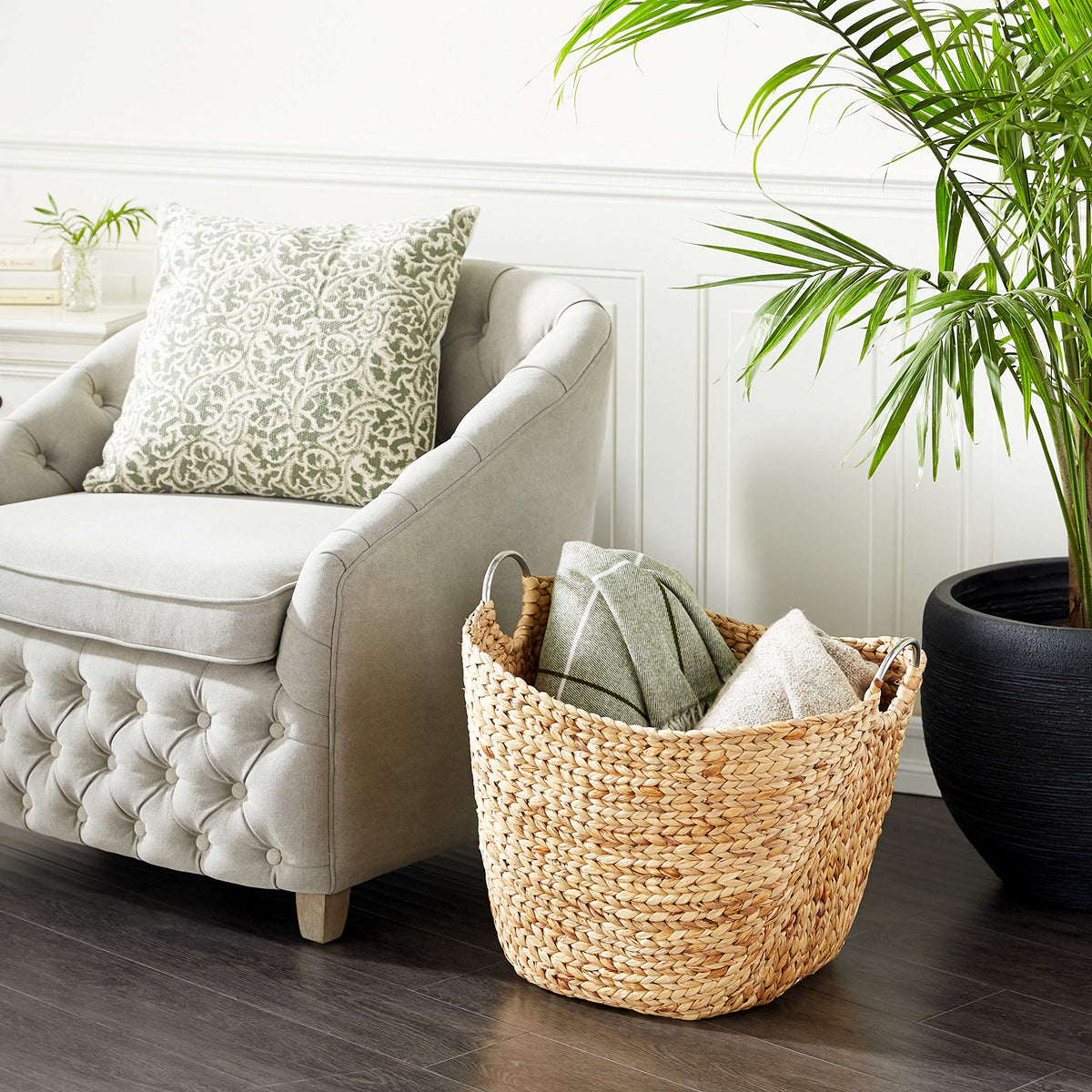 Deco 79 seagrass basket with ring handles ideal for organizing living room essentials