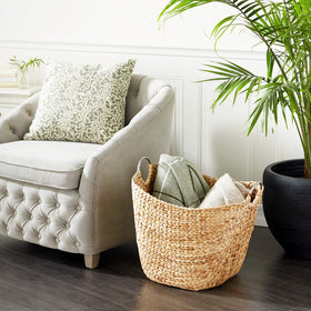 Deco 79 seagrass basket with ring handles ideal for organizing living room essentials