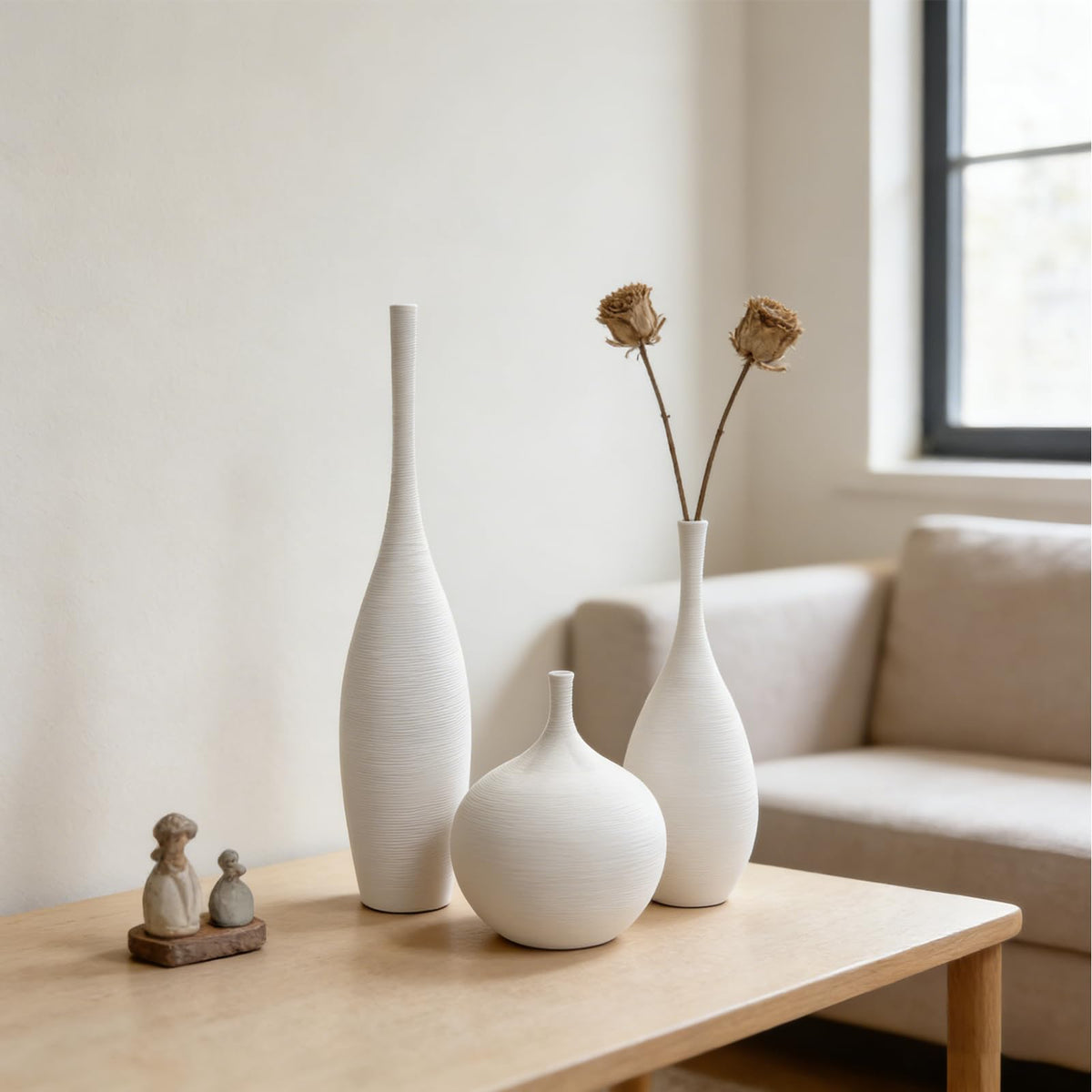 Decorative dried flower display with DecoVlog ceramic vases on a shelf.