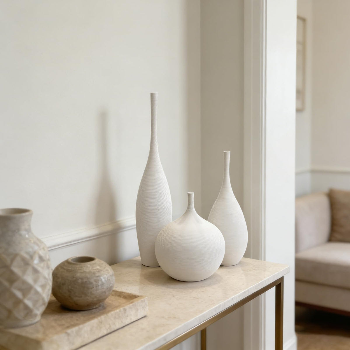 Three vases arranged with pampas stems to enhance living room ambiance.