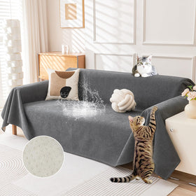 Deep Dream cat-scratch resistant couch cover on a dark grey sofa protects upholstery.