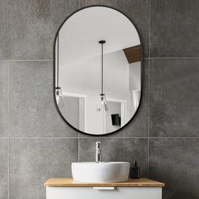 Delma 36x24 oval mirror over sink provides modern elegance and easy grooming.