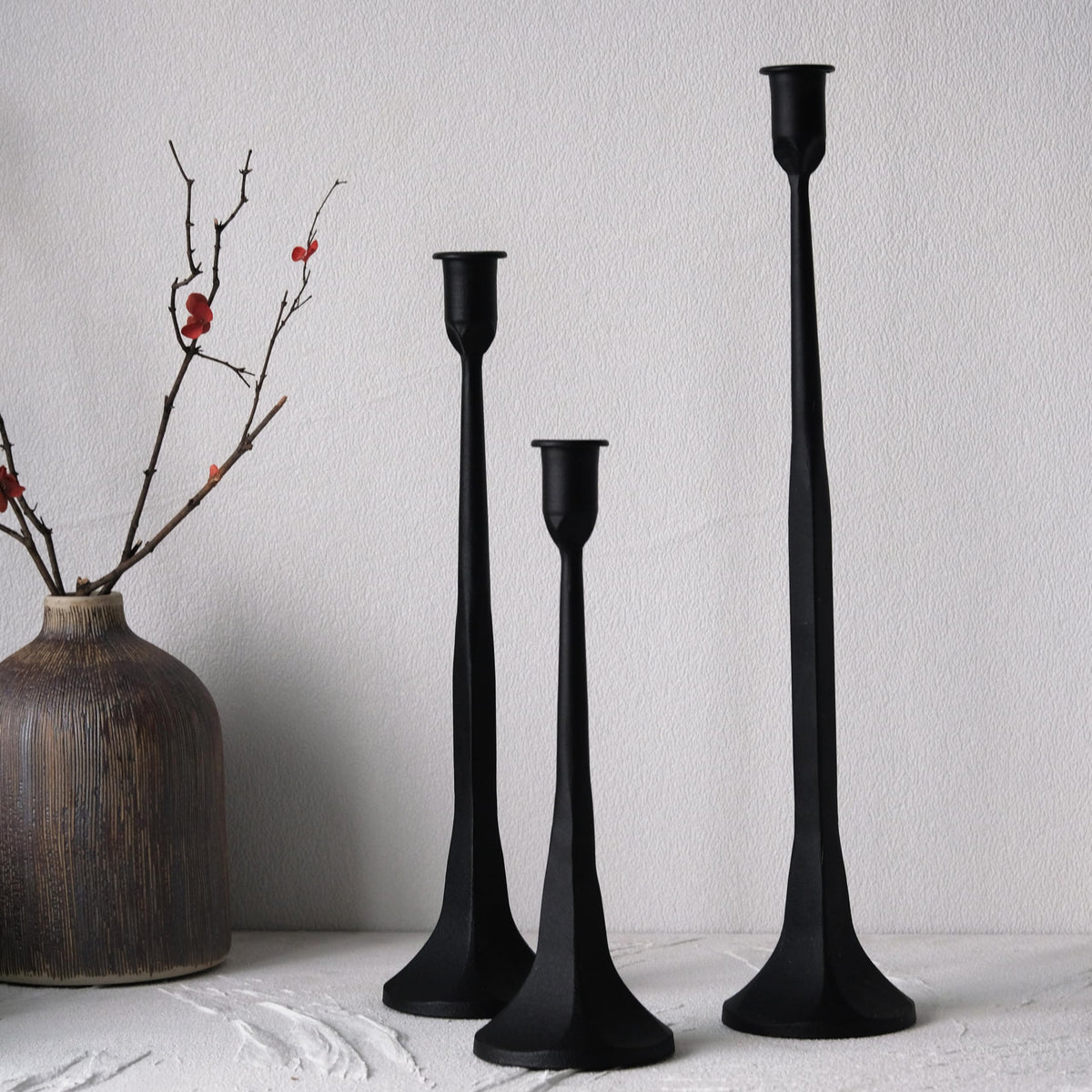Denique iron taper candle holder small height on table with soft lighting