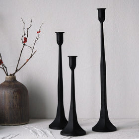 Denique iron taper candle holder small height on table with soft lighting