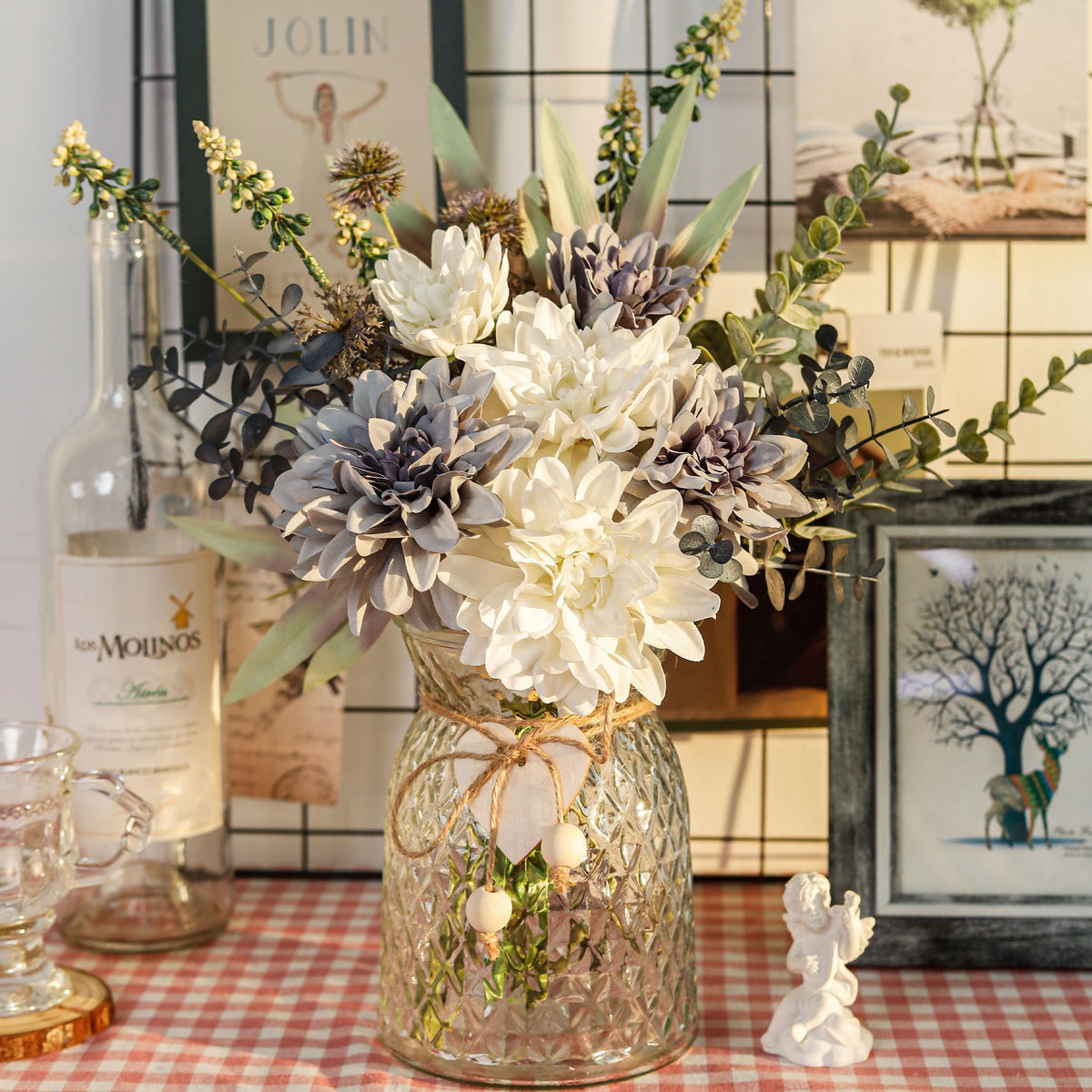 Der Rose navy blue dahlias with greenery in vase for office decor.