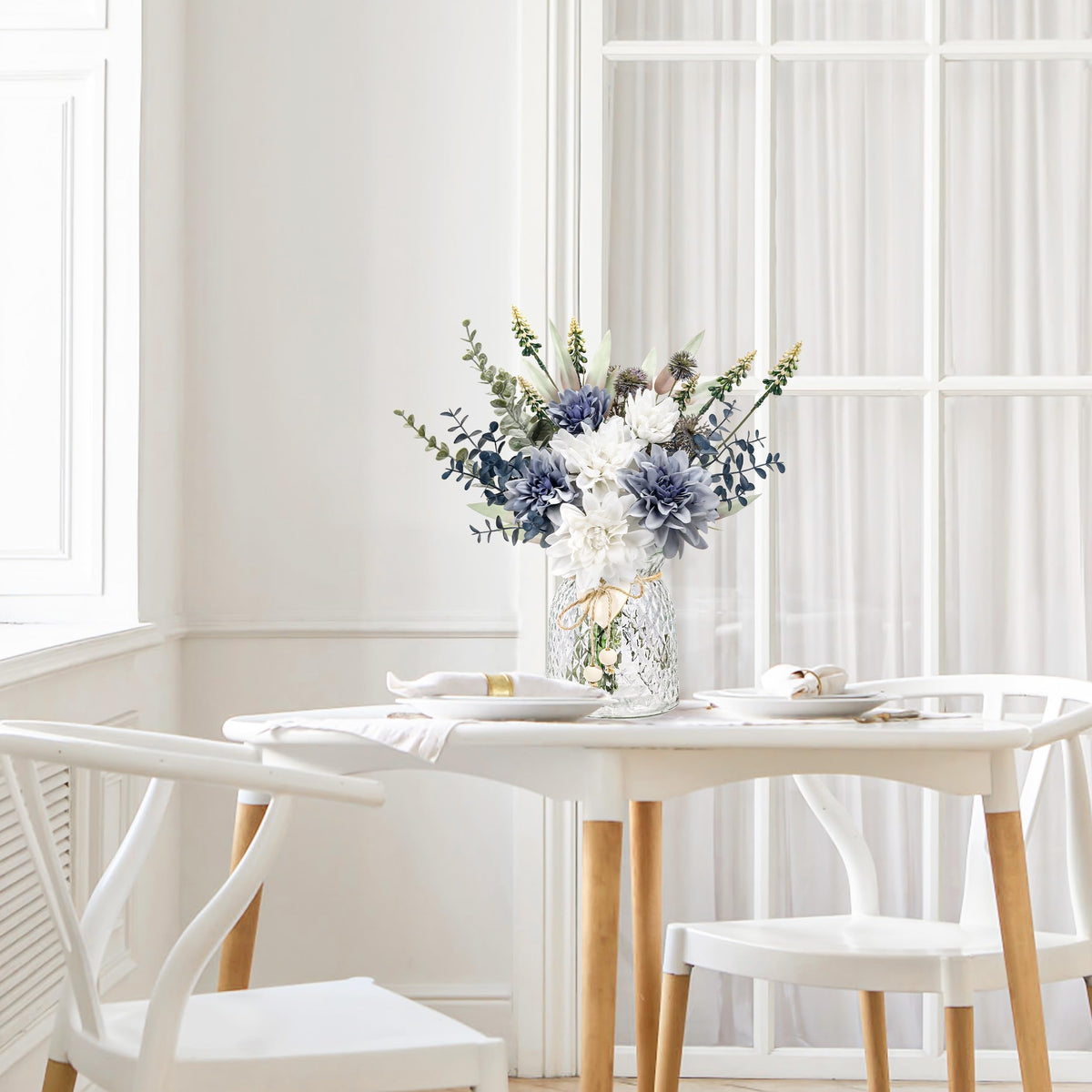 Der Rose synthetic blue dahlias with eucalyptus in vase for mantel decor.