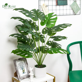 Living room decor with tall faux monstera adds lush vibe.