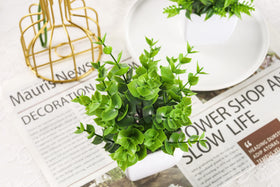 Der Rose versatile fake plants pair well with shelves and countertops.