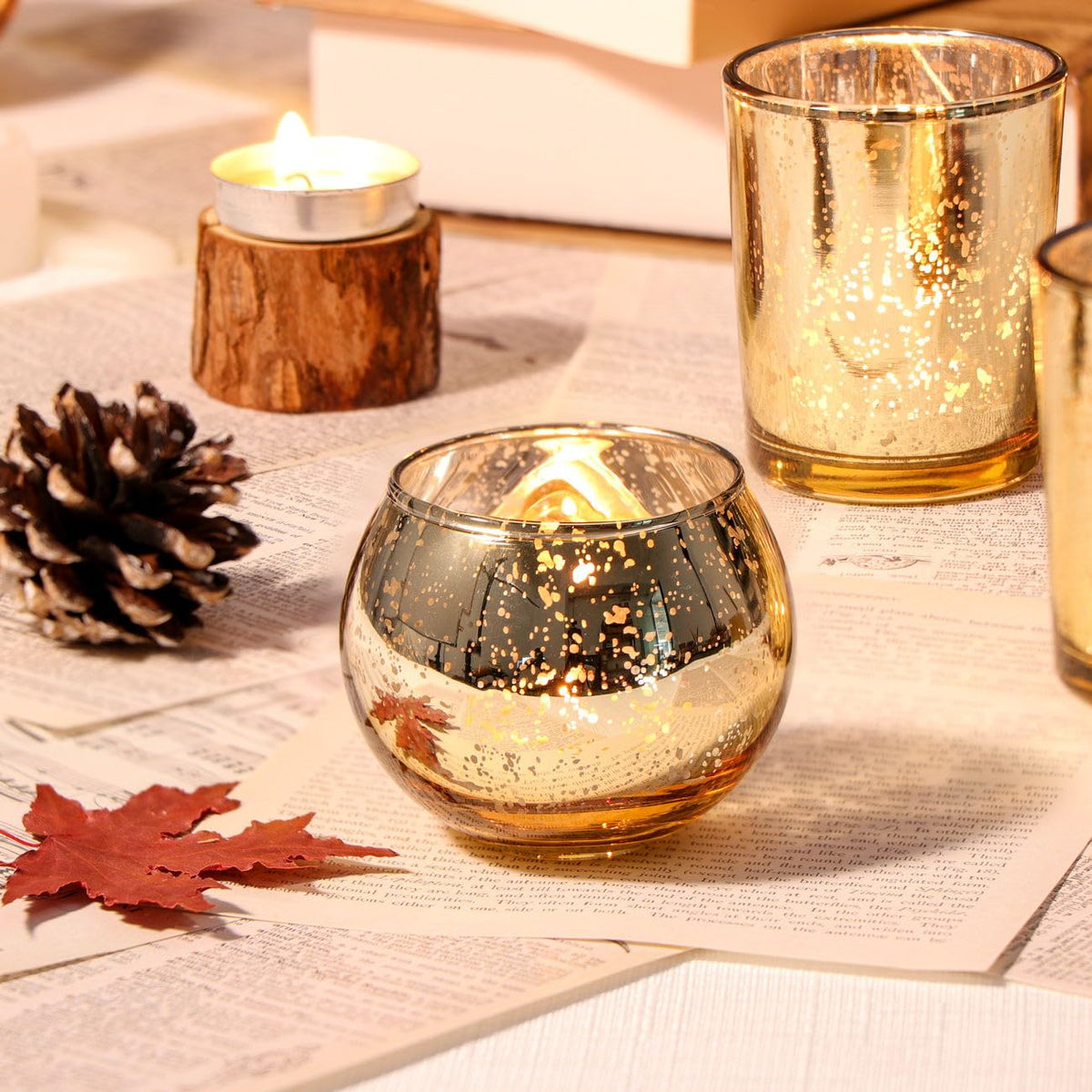 DEVI 2-inch round mercury glass votives for tea lights with a warm glow.