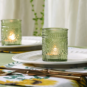 DEVI green glass tealight holder with sunflower embossing adds vintage charm.
