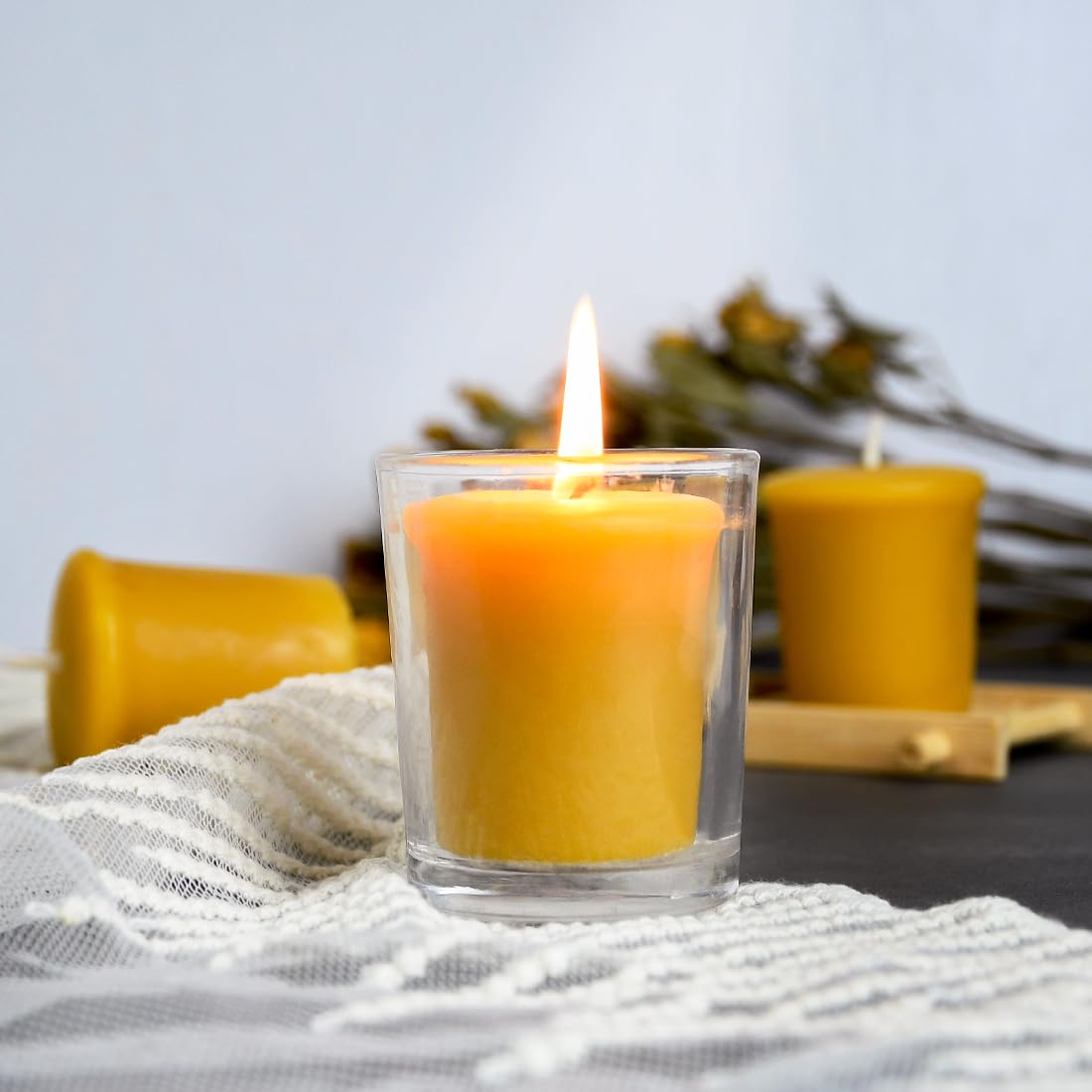 Cozy room scene shows warm candlelight from DEYBBY votives.