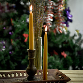 Lit DEYBBY beeswax taper candles at a romantic dinner.