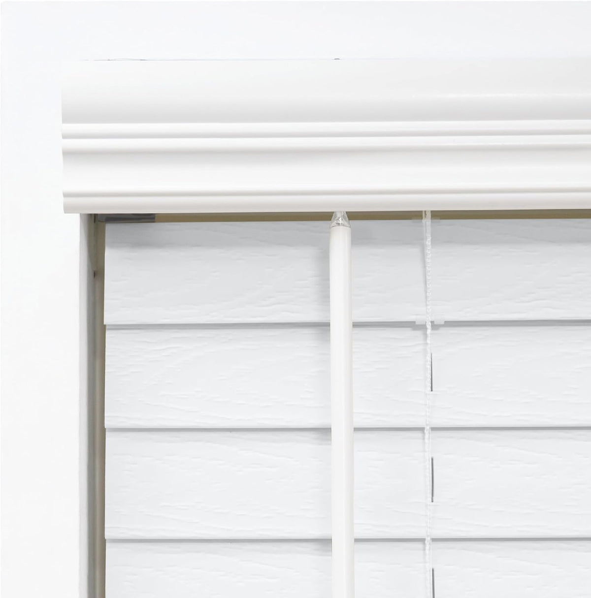 DEZ FURNISHINGS cordless faux wood blind valance detail adds polished finish.