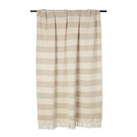 DII cabana striped blanket on sofa adds warm color and texture