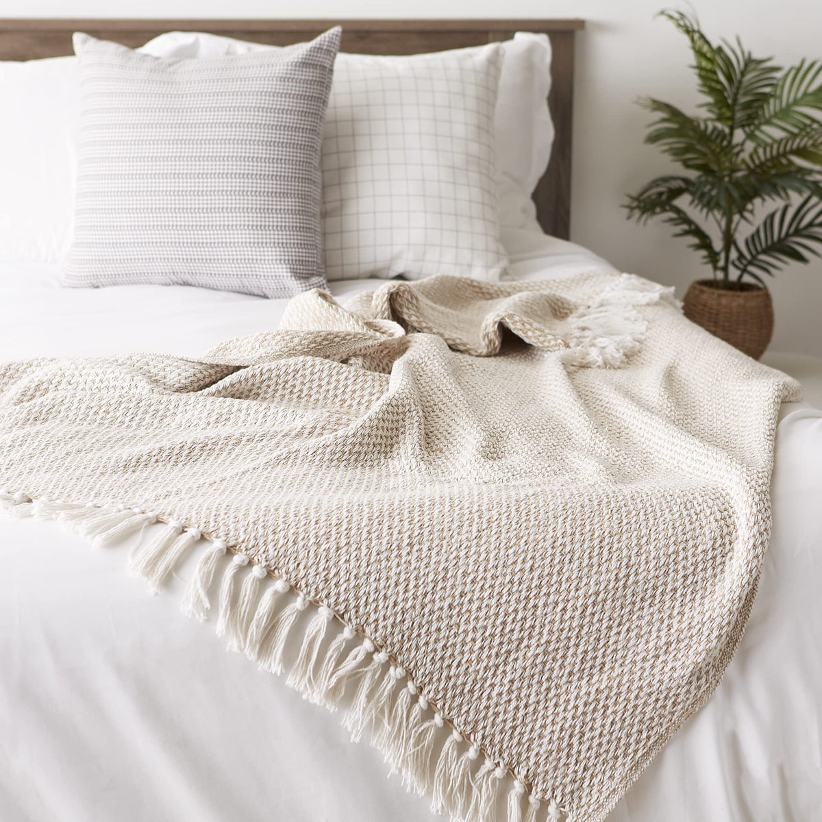 DII woven throw on a bed creates cozy ambience and layering