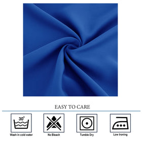Diraysid Royal Blue grommet curtains in a nighttime living room with reduced light.