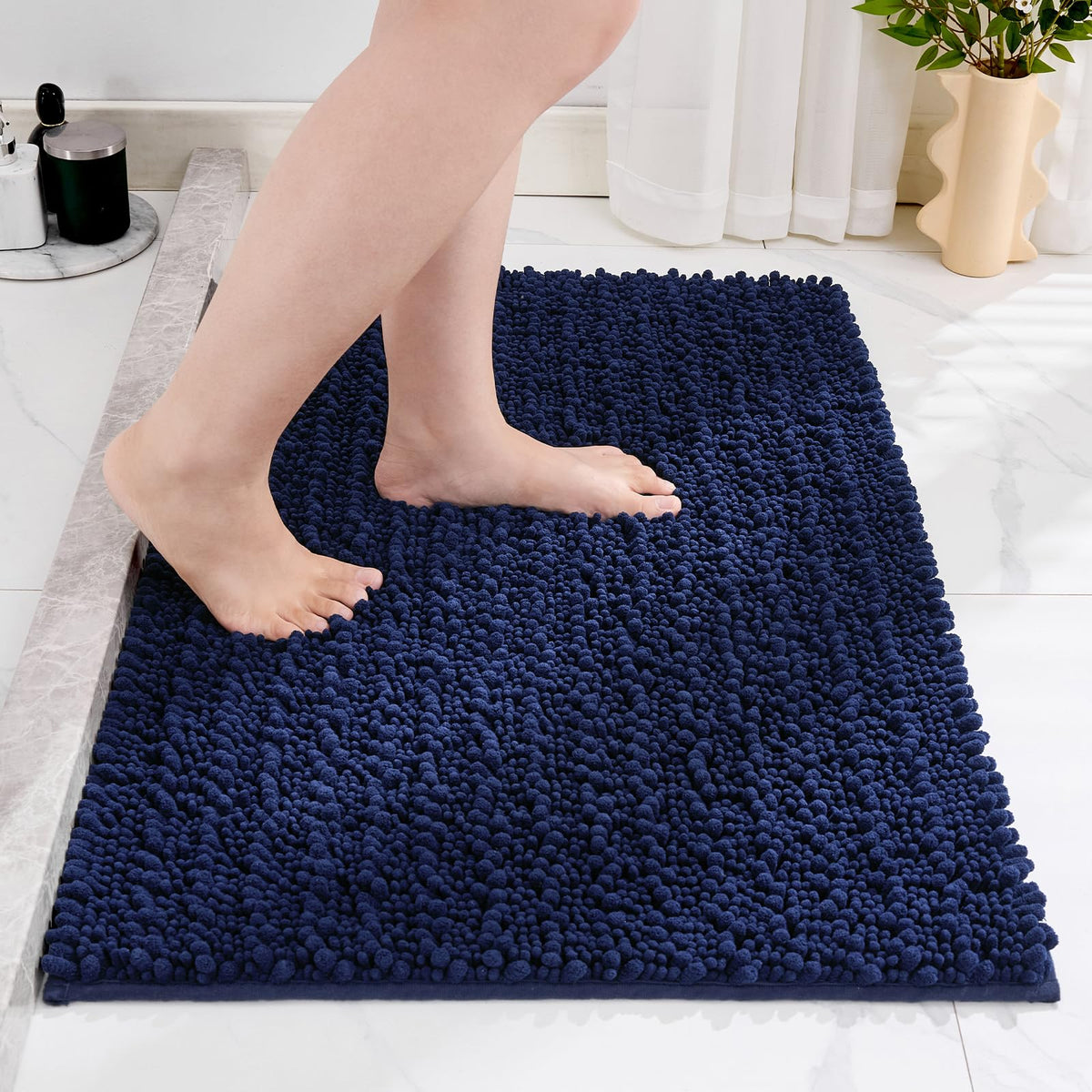 Disolla navy blue rug placed in front of vanity creates a cozy, absorbent area.