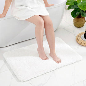 Disolla white bath rug 24x36 with plush pile for cozy feet after showers.