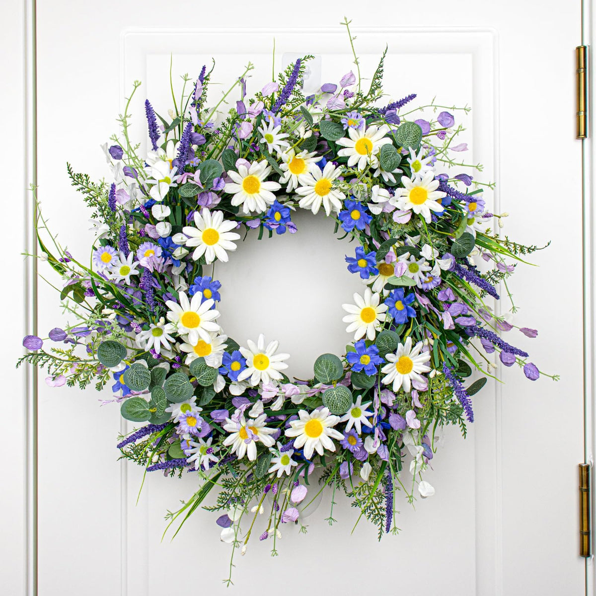 DIYFLORU entryway wreath combines blue blooms with greenery for year round appeal.
