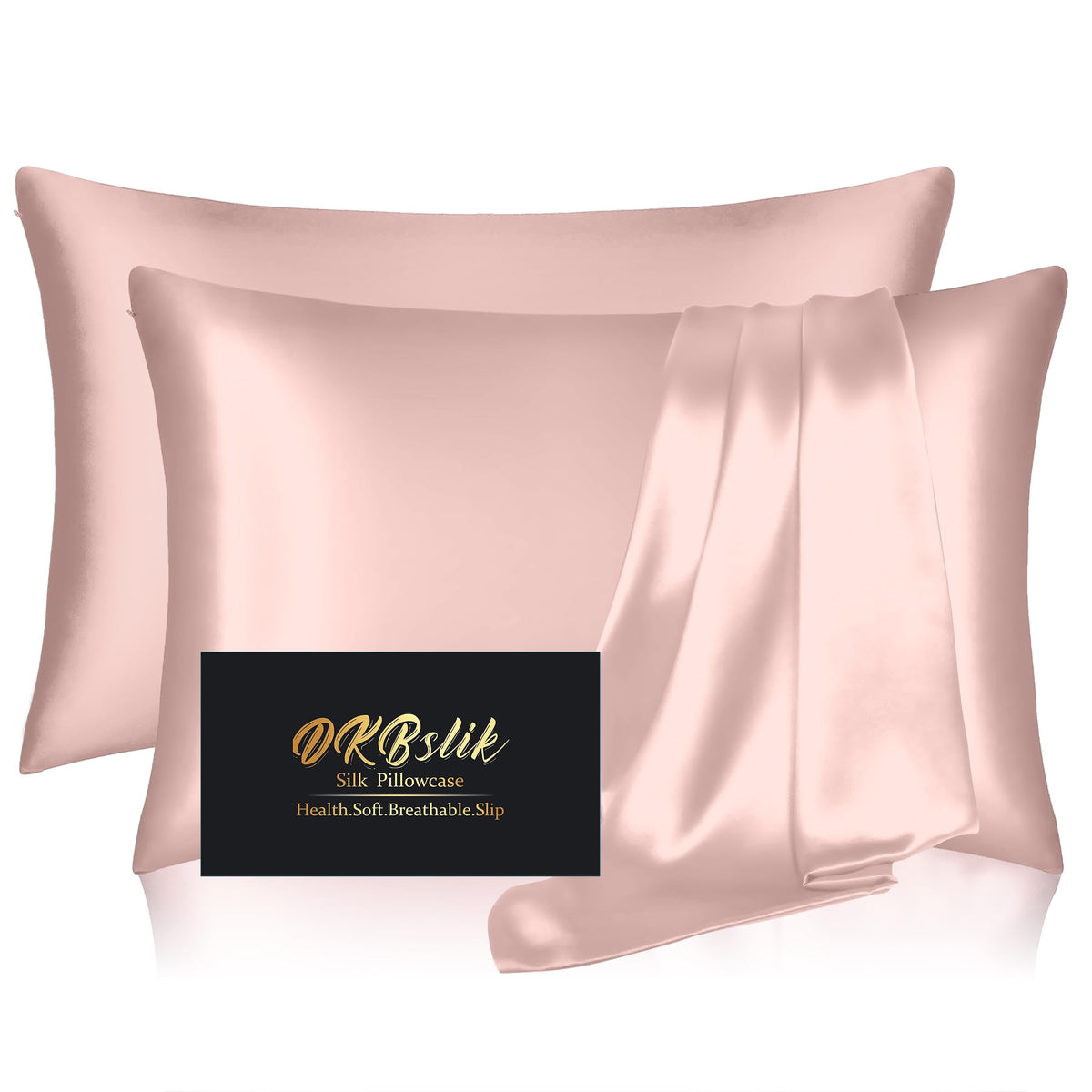 DKBslik silk pillowcase two-pack in coral on bed shows smooth surface and potential hair-skin benefit.