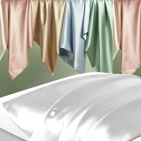 DKBslik silk pillowcase on bed demonstrates soft texture for cooling sleep.