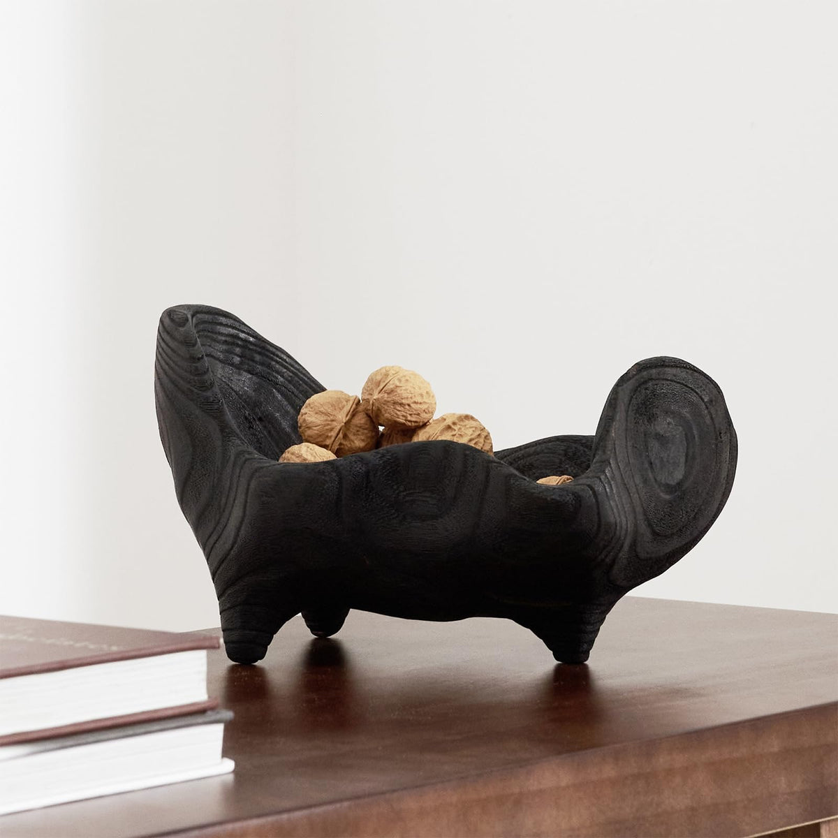 DN DECONATION oak wood black bowl serves as a centerpiece on coffee tables.