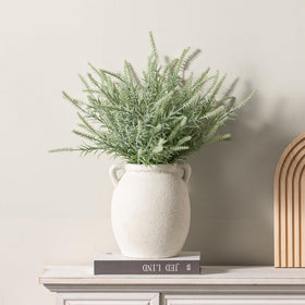 Dobbyby white-upgraded vase near fireplace, adds timeless charm to living room.