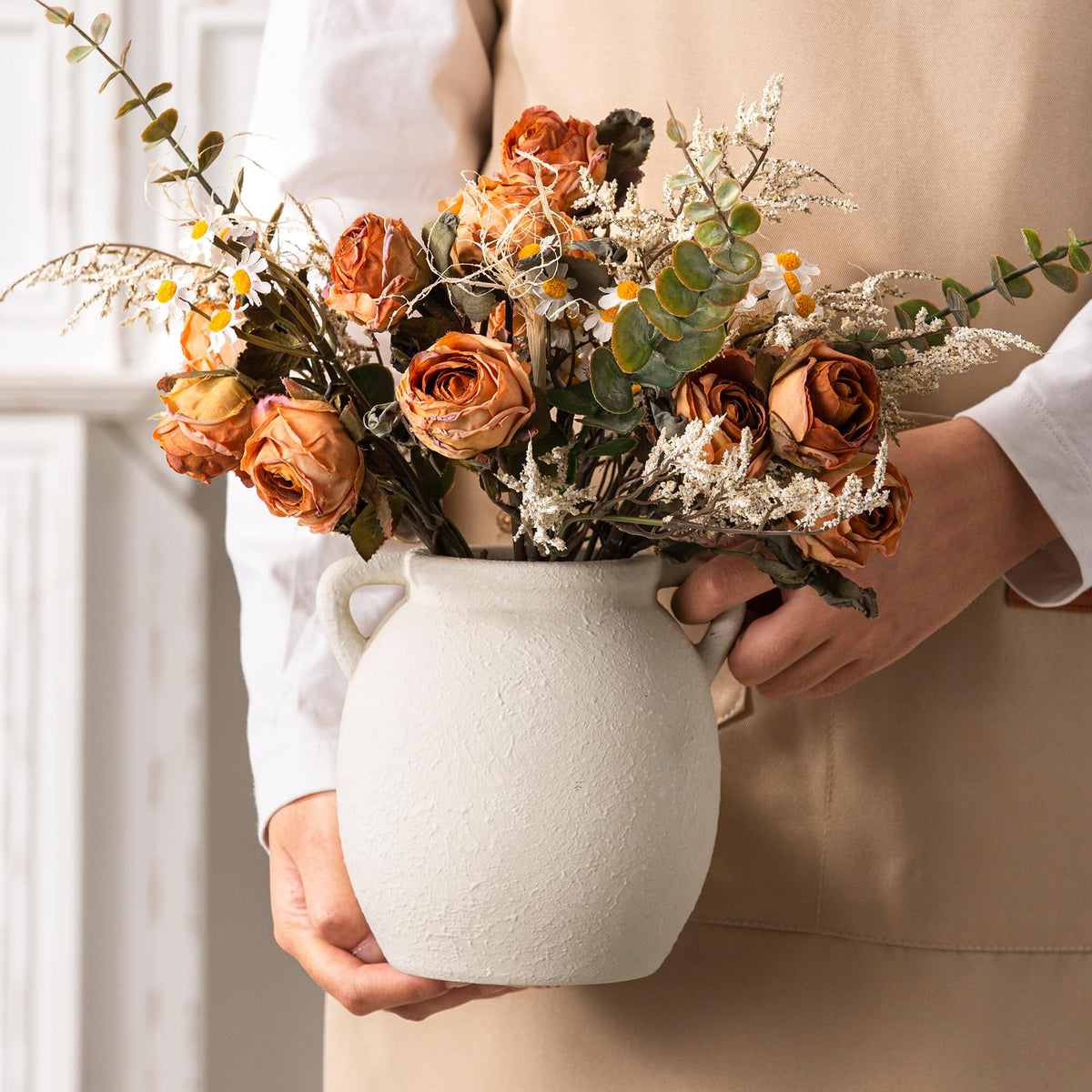 Dobbyby vase on table with boho vibe complements living room decor.