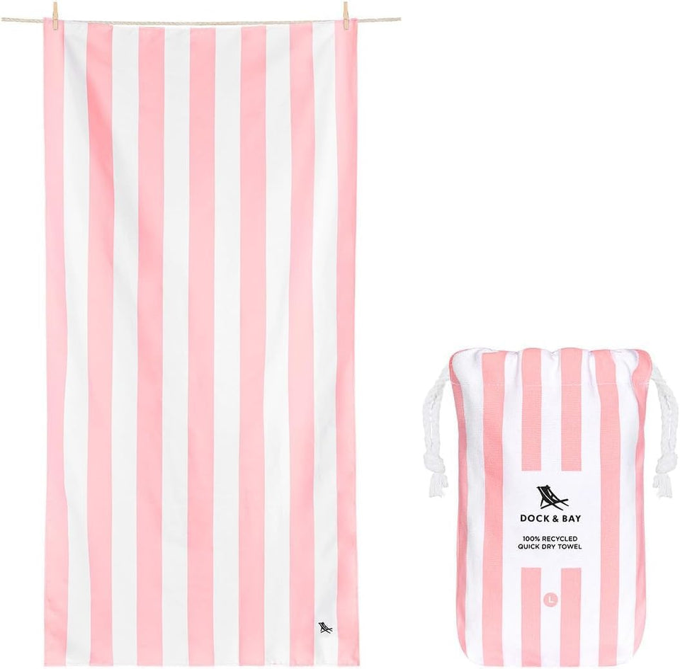 Dock & Bay Cabana light pink towel spread on warm sand; sand-free and quick-drying.