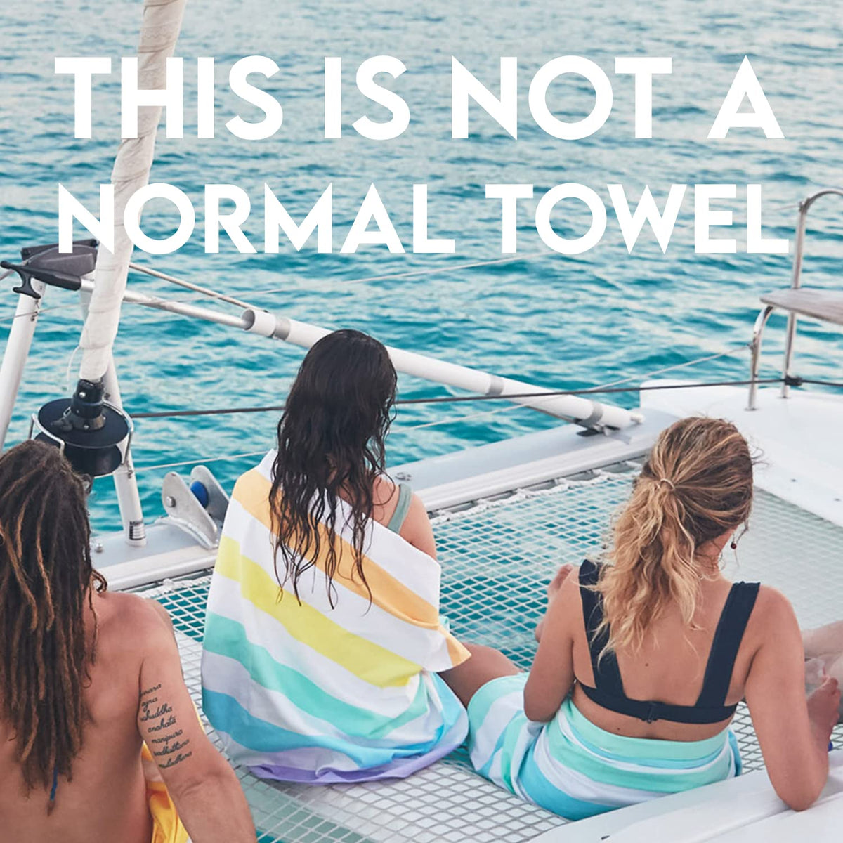 Dock and Bay extra-large 200x90cm towel stretched on beach for ample coverage.