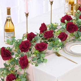 Dolicer eucalyptus garland close-up shows 8 red roses and realistic greenery.