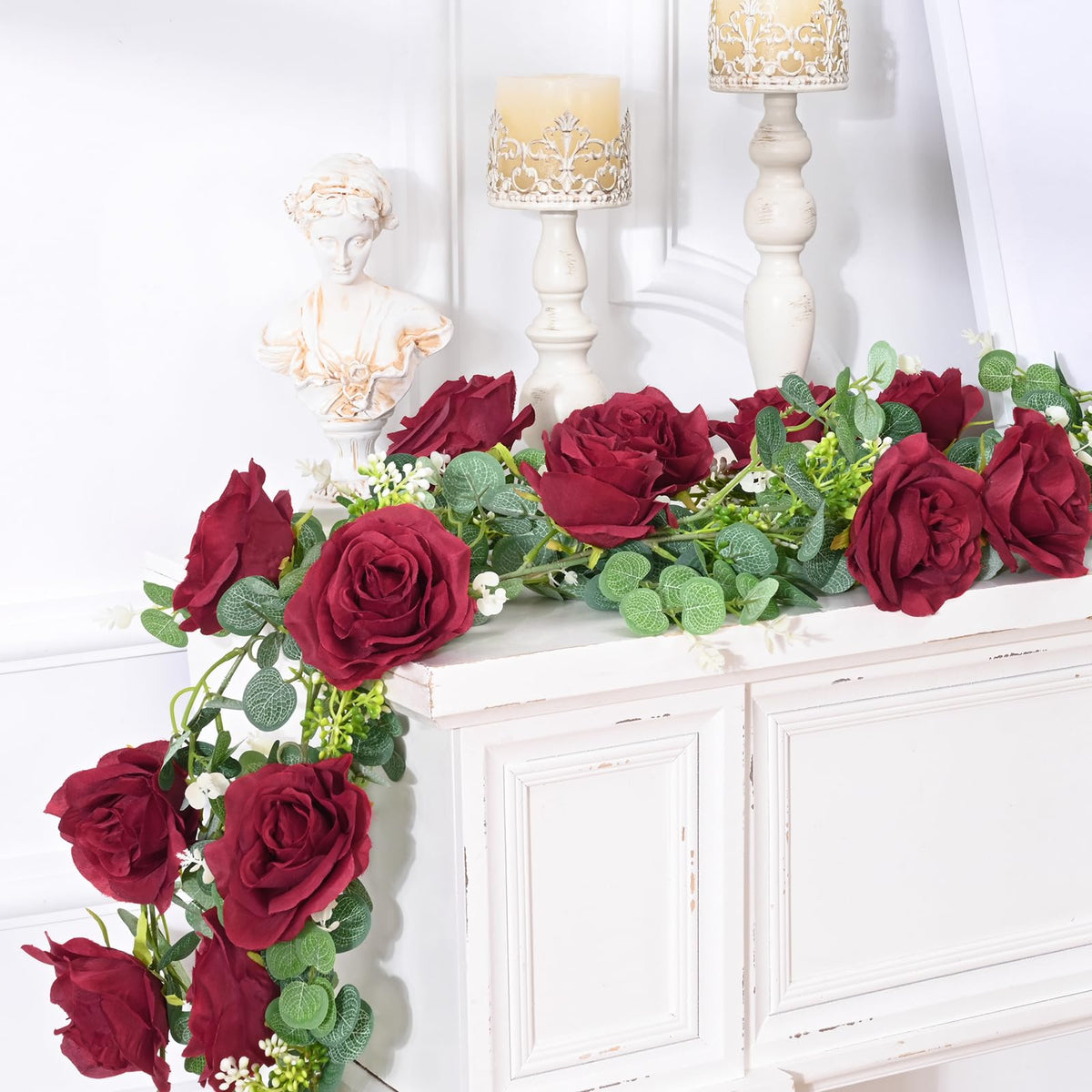 Dolicer wedding arch decor with red roses and lush leaves.