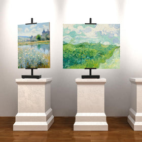 Donghome 18in black steel tabletop easel in use for plates, prints, or small canvases.