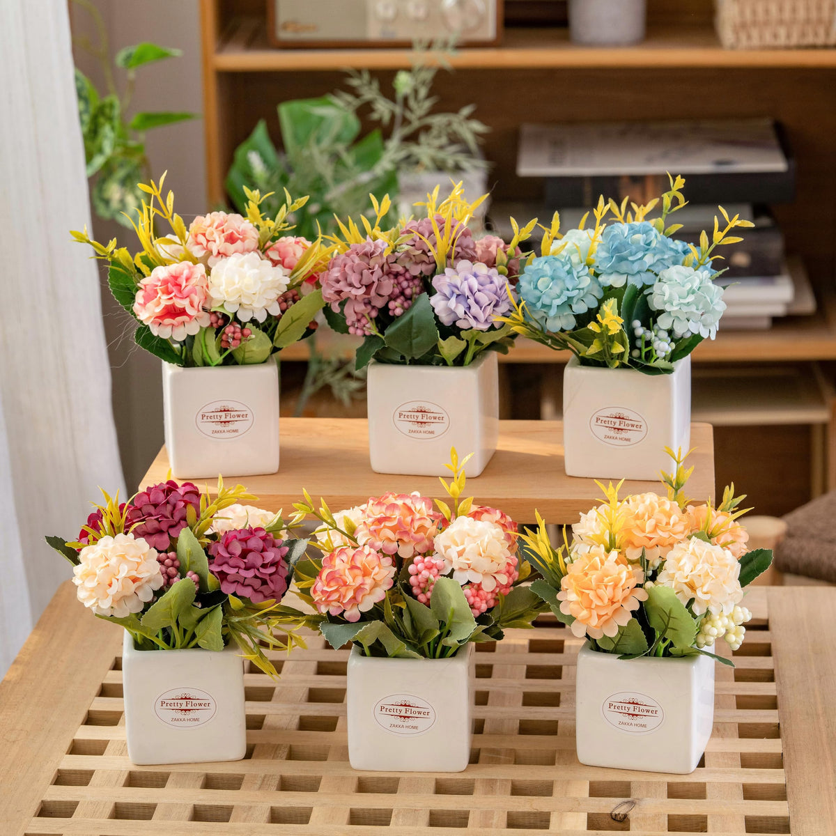 Donmills hydrangea arrangement in a ceramic pot; vibrant color mix brightens spaces.