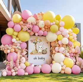 DOUBLE LAYER BALLOON pastel pink yellow arch kit forms a festive centerpiece.