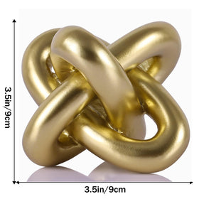 DOVDOV Three Knot Sculpture adds artistic texture to a coffee table.